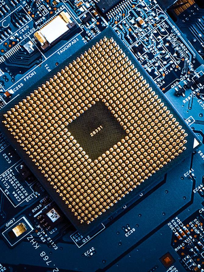 microprocessor-close-up-gold-pins-circuit-board Close-up of computer microprocessor with gold pins on printed circuit board, brightly lit to highlight metallic sheen and depth.